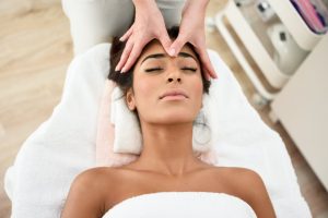 Woman getting facial massage. 