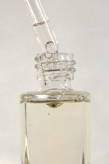 skin serum in a glass bottle